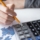 cropped-view-sales-manager-using-calculator
